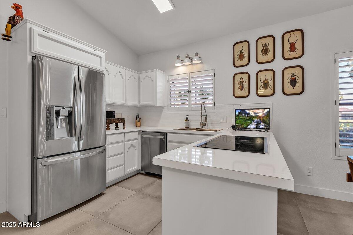 7614 East Gila Bend Road Scottsdale, AZ 85258 - Photo 5 of 36 a kitchen with a refrigerator and a sink