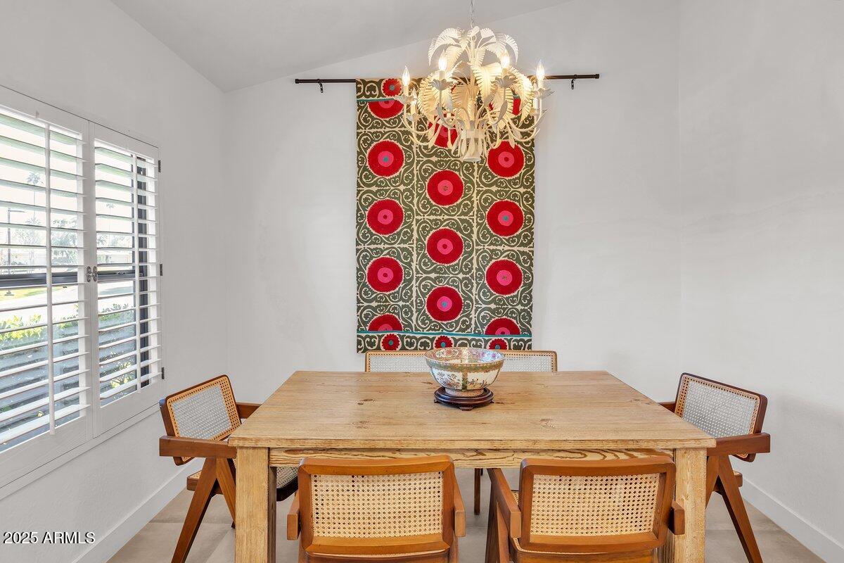 7614 East Gila Bend Road Scottsdale, AZ 85258 - Photo 9 of 36 a view of a dining room with furniture and wooden floor