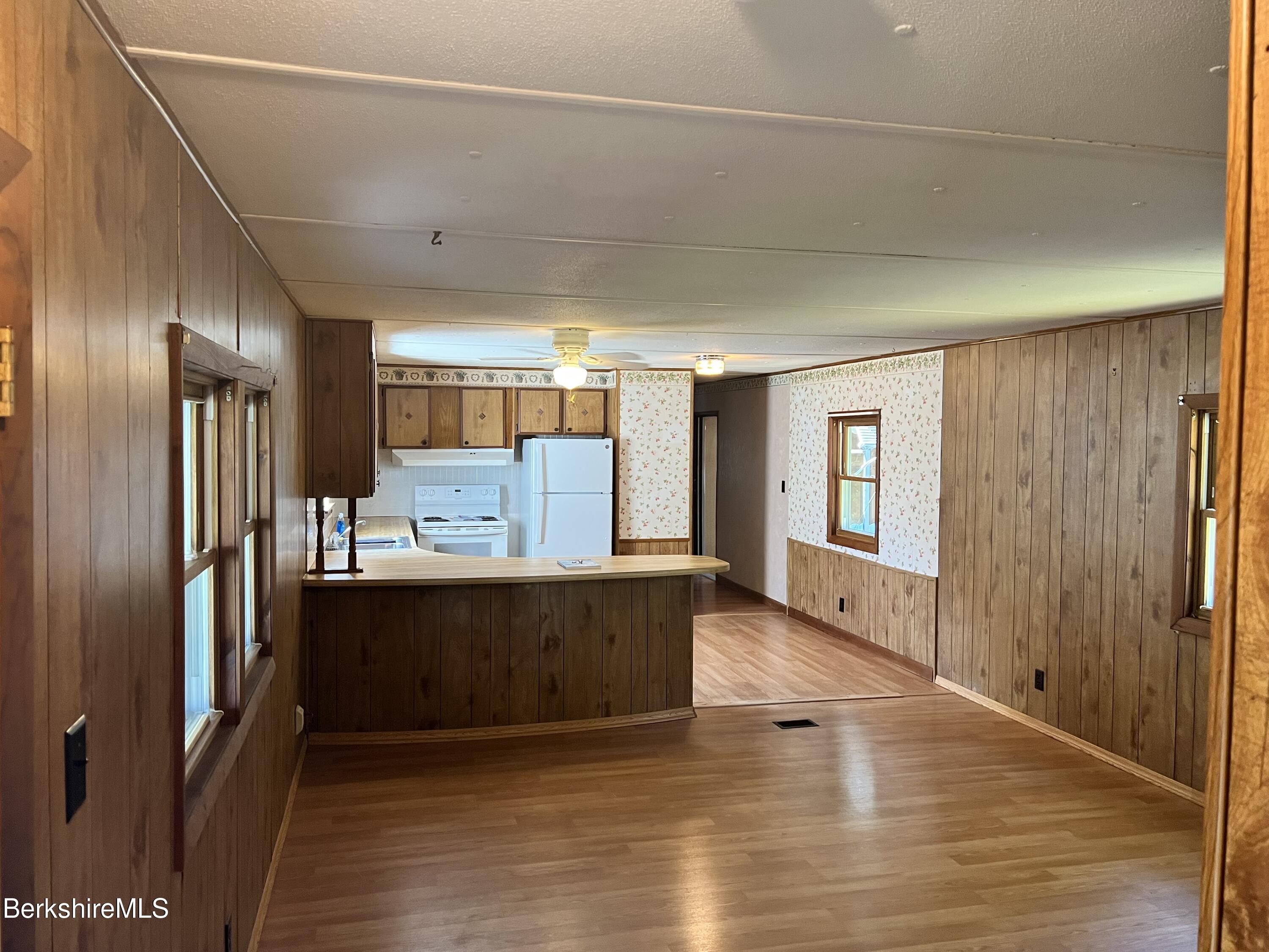 405 Pittsfield Road, Unit H12 Lenox, MA 01240 - Photo 3 of 13 a view of kitchen with cabinets and wooden floor