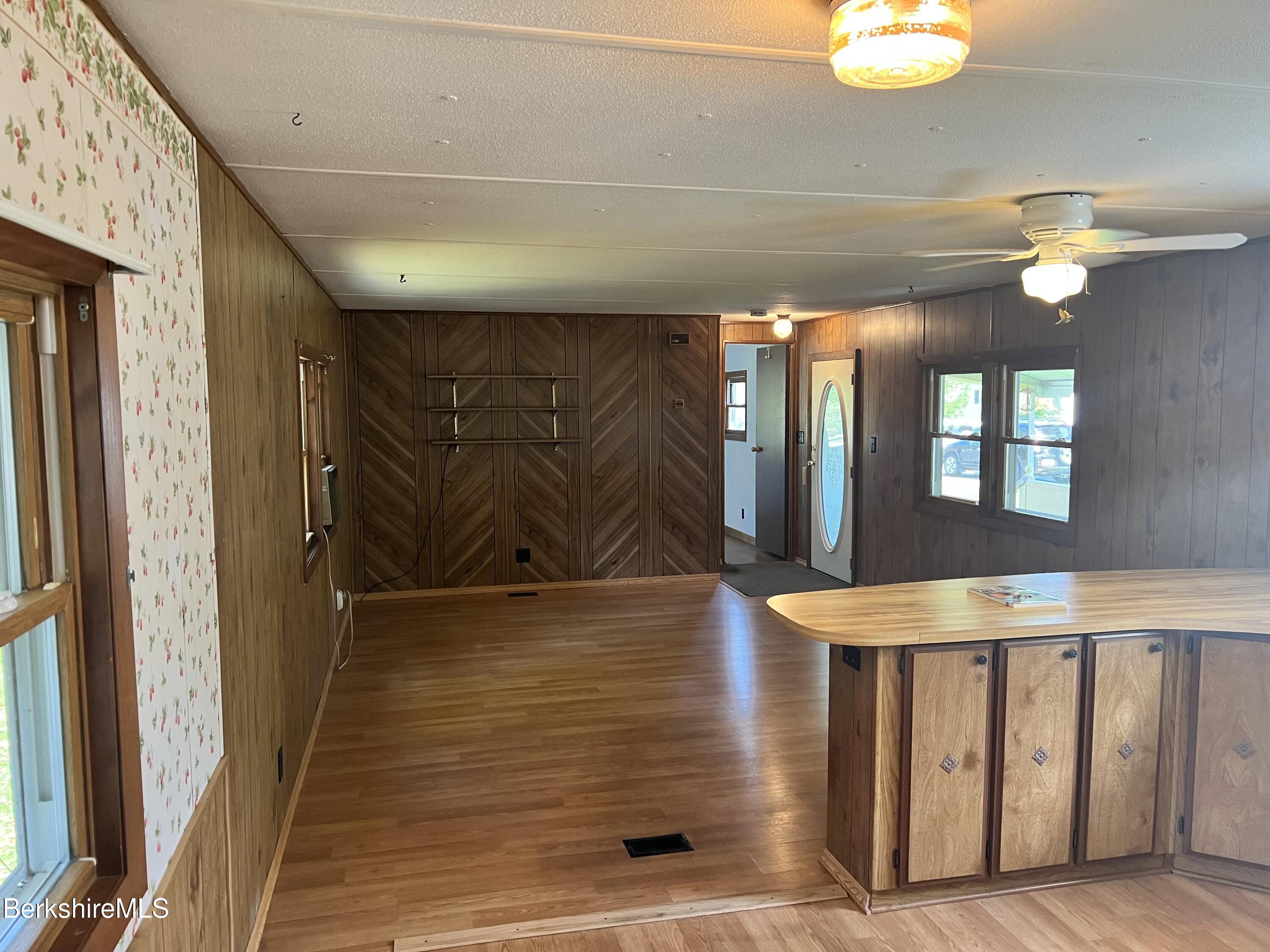 405 Pittsfield Road, Unit H12 Lenox, MA 01240 - Photo 4 of 13 a view of a hallway with windows
