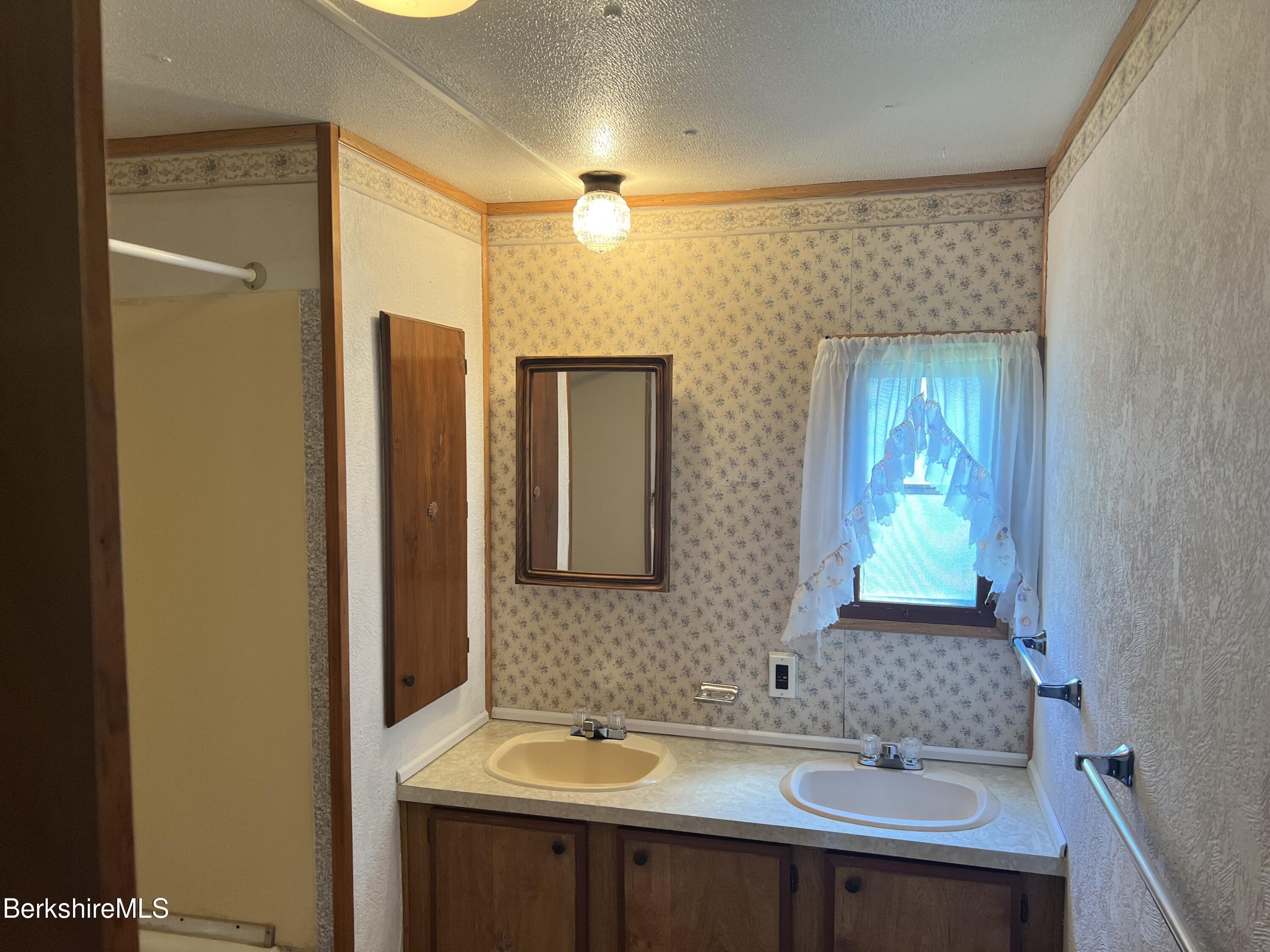 405 Pittsfield Road, Unit H12 Lenox, MA 01240 - Photo 9 of 13 a bathroom with a sink and a mirror