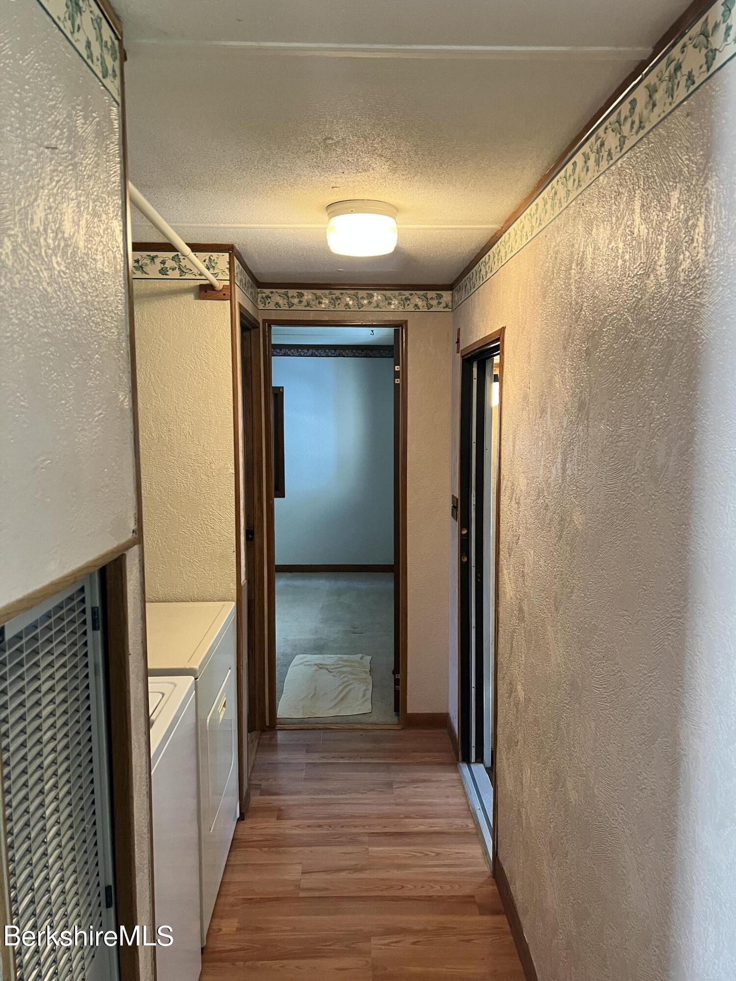 405 Pittsfield Road, Unit H12 Lenox, MA 01240 - Photo 10 of 13 a view of hallway with wooden floor