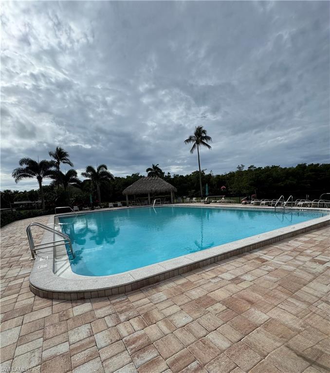 15 Bluebill Avenue, Unit 1006 Naples, FL 34108 - Photo 4 of 25 Community pool with a patio area