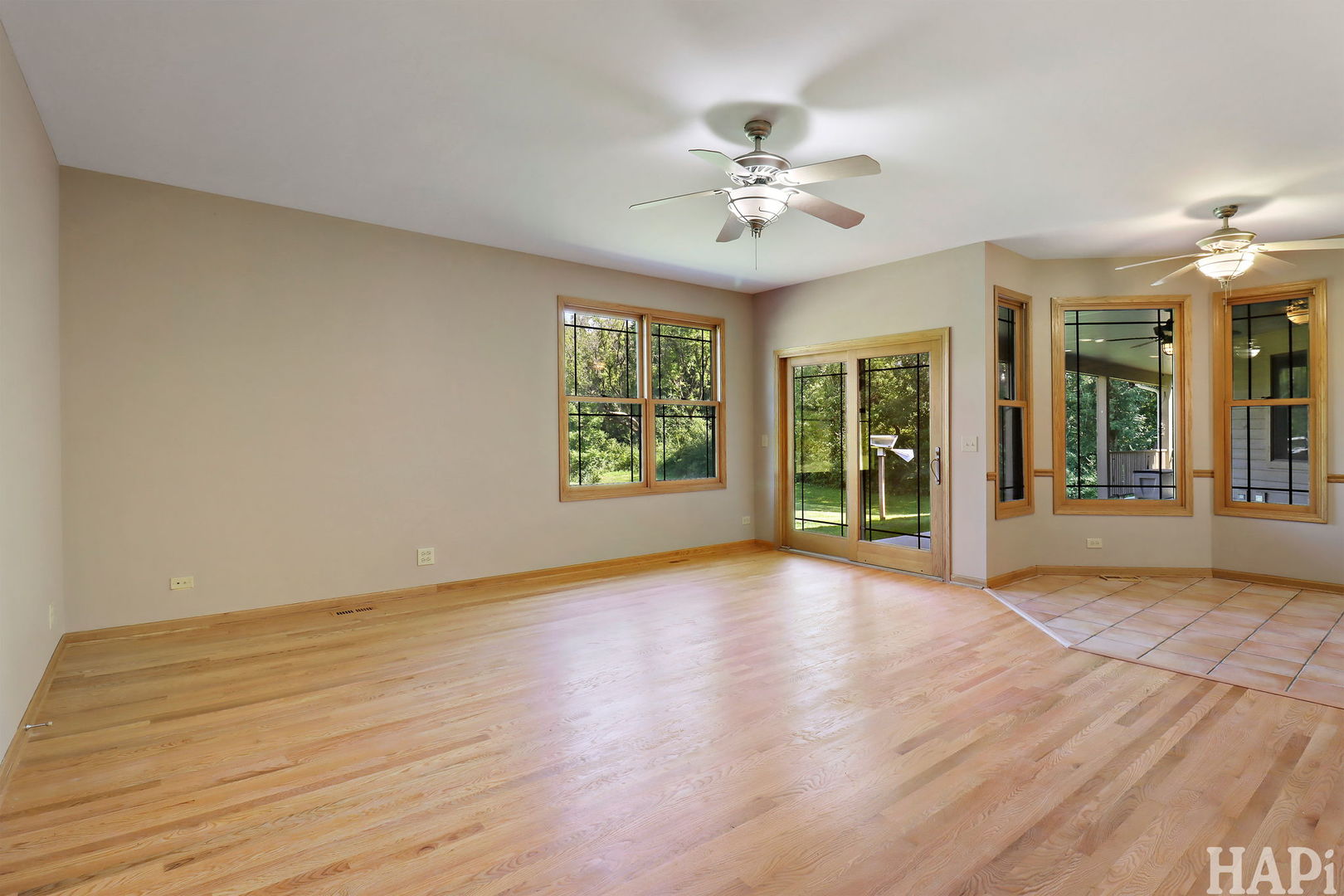 9014 Glacier Ridge Richmond, IL 60071 - Photo 16 of 48 a view of an empty room with a window and wooden floor