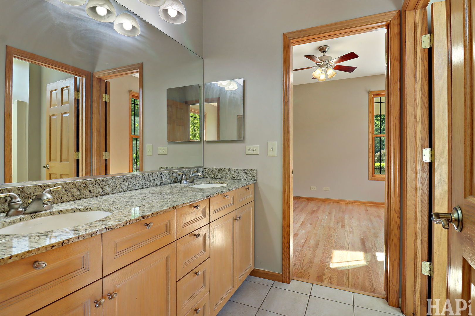 9014 Glacier Ridge Richmond, IL 60071 - Photo 36 of 48 a bathroom with a granite countertop sink and a mirror