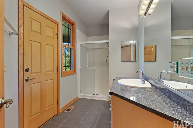 a bathroom with a granite countertop sink and a mirror