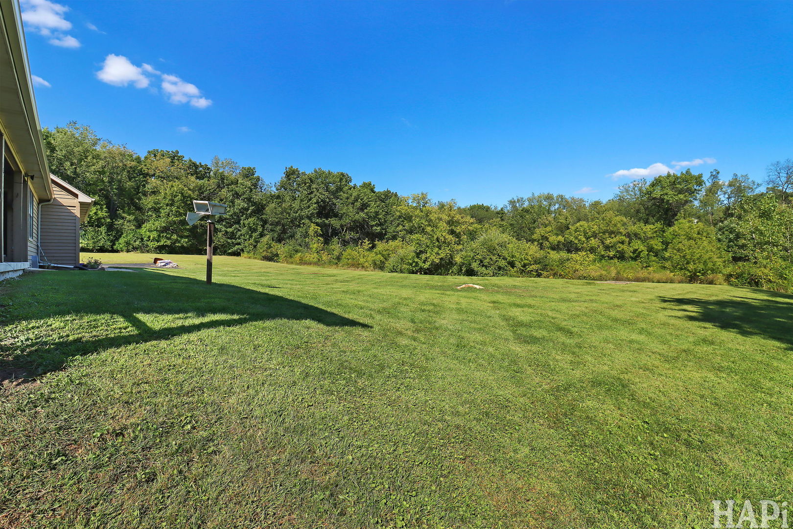 9014 Glacier Ridge Richmond, IL 60071 - Photo 45 of 48 a view of a grassy field with trees in the background
