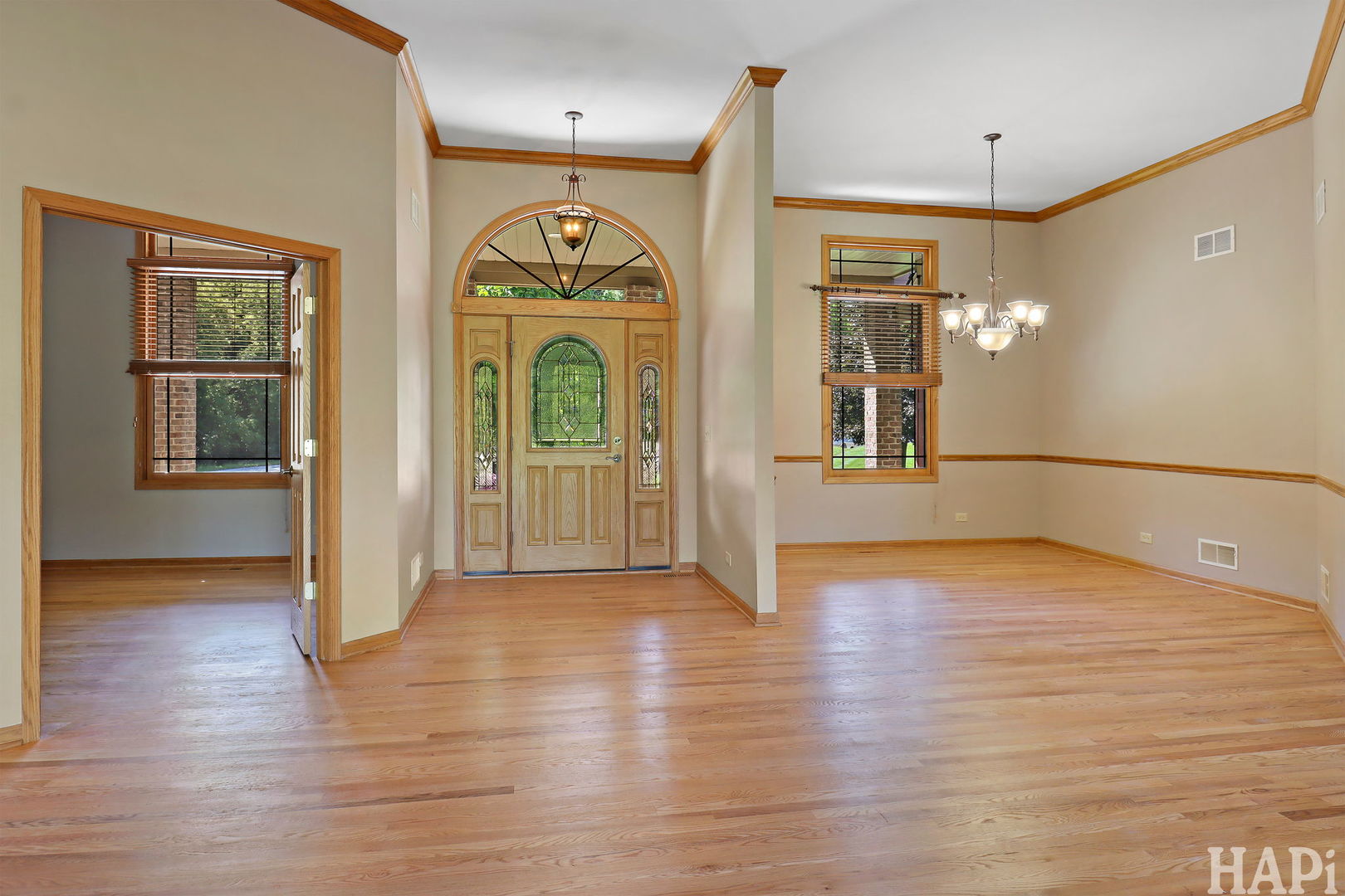9014 Glacier Ridge Richmond, IL 60071 - Photo 5 of 48 a view of a hallway with wooden floor and a living room
