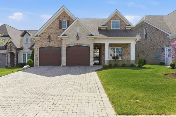 a front view of a house with a yard and garage