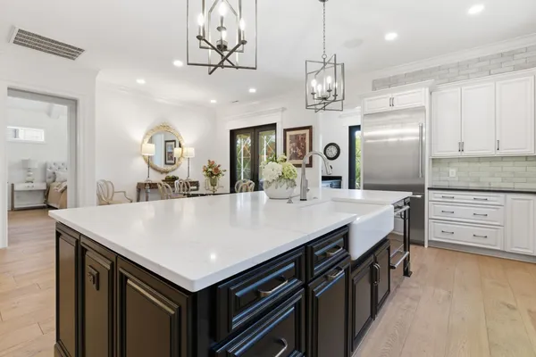 a kitchen with a stove a refrigerator and a sink
