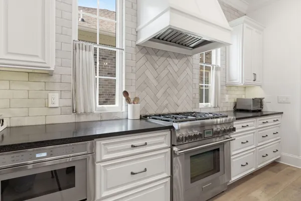 a kitchen with cabinets appliances and a window