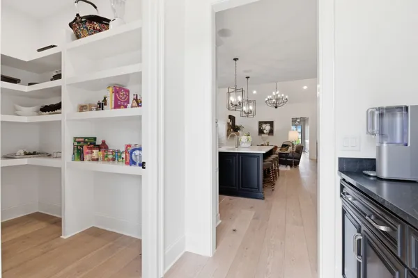 a kitchen with granite countertop a refrigerator and cabinets