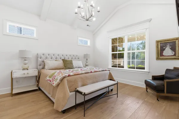 a spacious bedroom with a bed and a couch