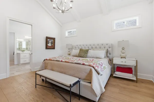 a bedroom with a bed and a chandelier