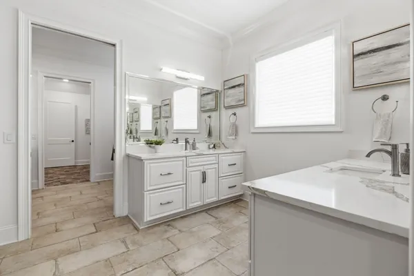 a bathroom with a sink double vanity and a mirror