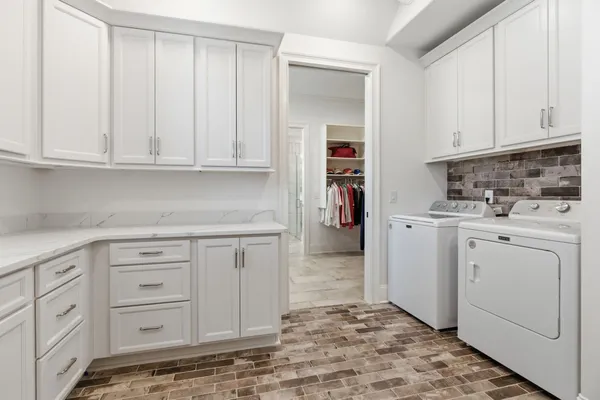 a kitchen with white cabinets and white appliances