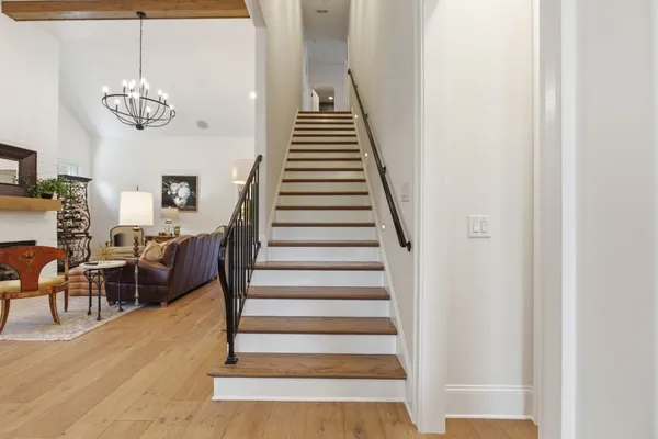 a view of entryway and hall with wooden floor