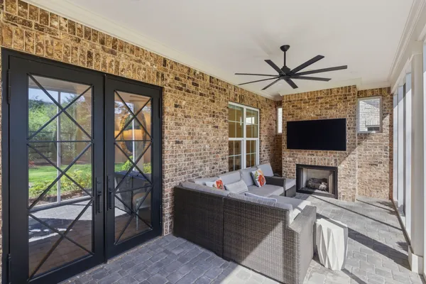 a living room with furniture a flat screen tv and a fireplace