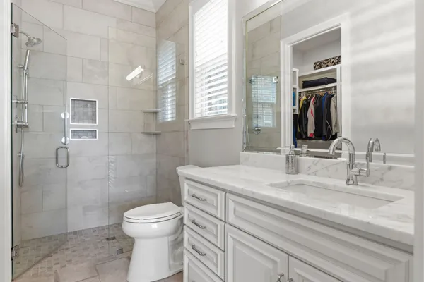 a bathroom with a sink toilet and shower