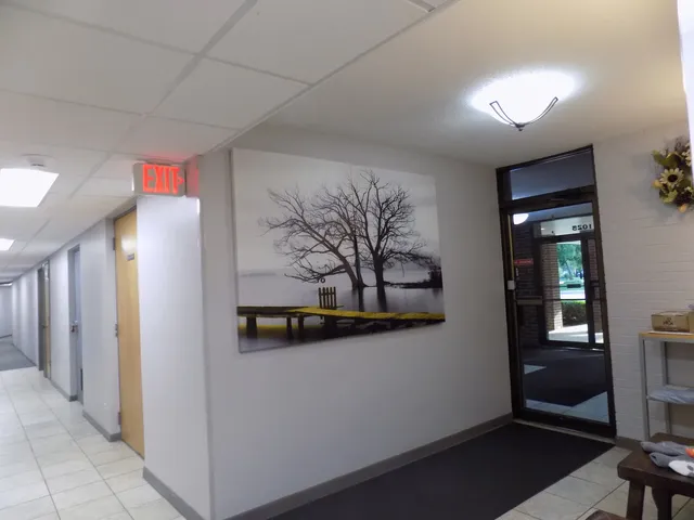 a view of a hallway with paintings on the wall