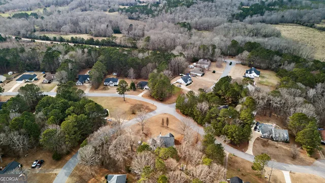an aerial view of a house with yard swimming pool and lake view