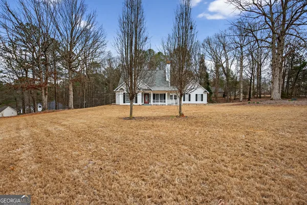a view of large trees with a house