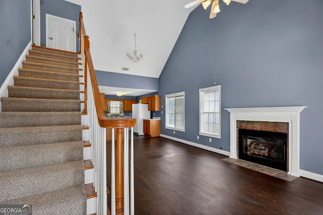 a view of an entryway with wooden floor fireplace and a window
