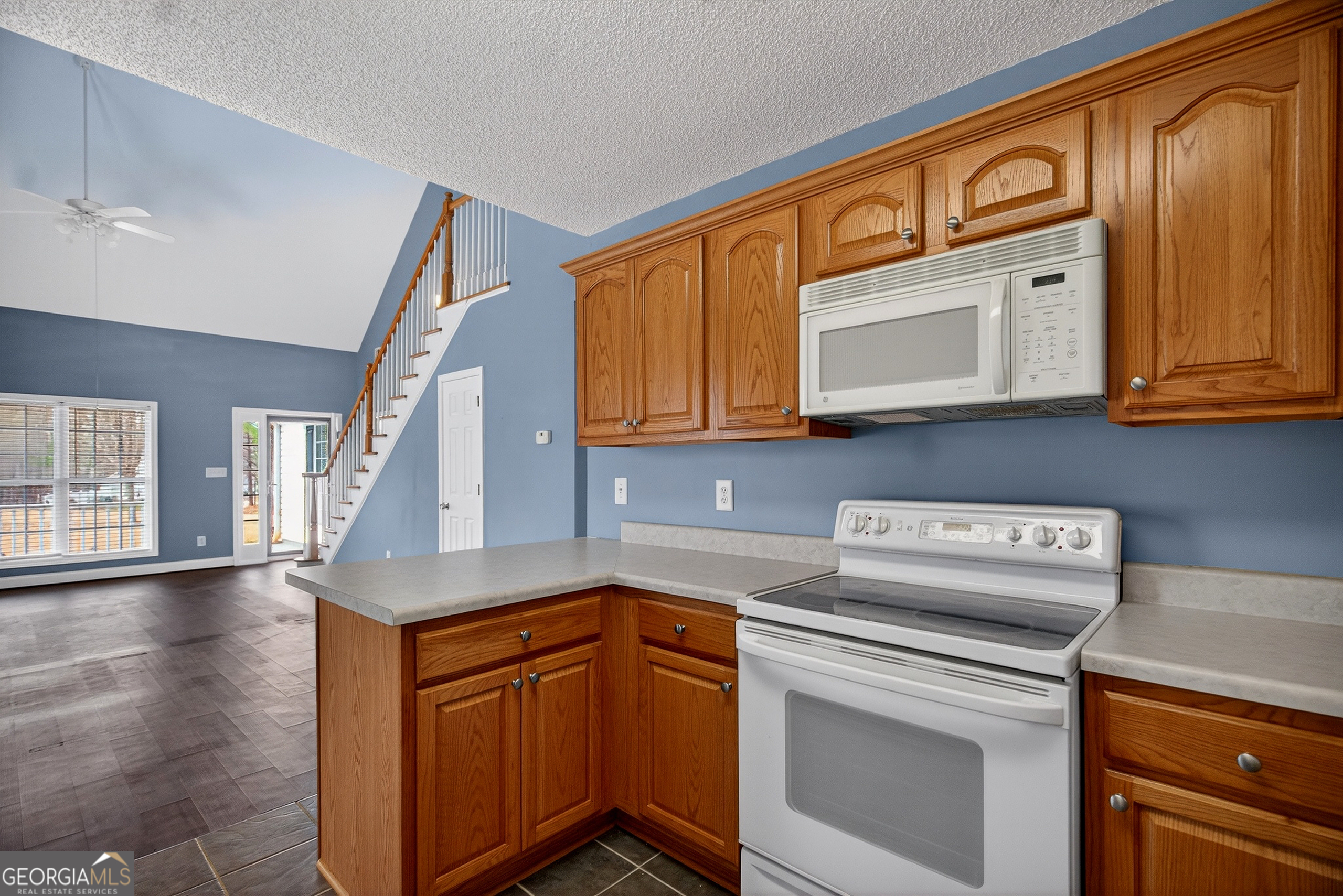 107 Waters Edge Drive LaGrange, GA 30240 - Photo 10 of 29 a kitchen with stainless steel appliances granite countertop a sink a stove cabinets and entryway
