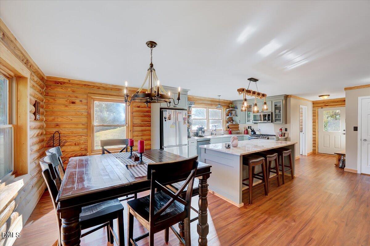 8545 Grassy Creek Road Oxford, NC 27565 - Photo 12 of 39 a view of a dining room with furniture and wooden floor