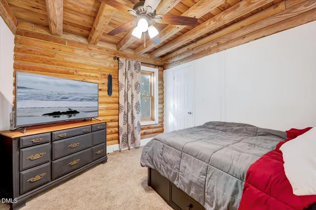 a bedroom with a bed and a television