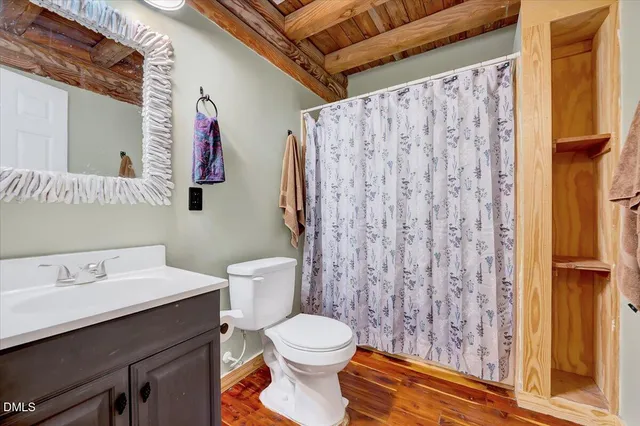 a bedroom with a bed a dresser and a large window