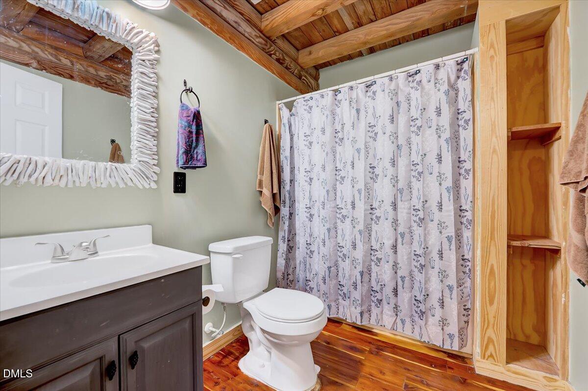 8545 Grassy Creek Road Oxford, NC 27565 - Photo 18 of 39 a bathroom with a sink a toilet and shower curtain