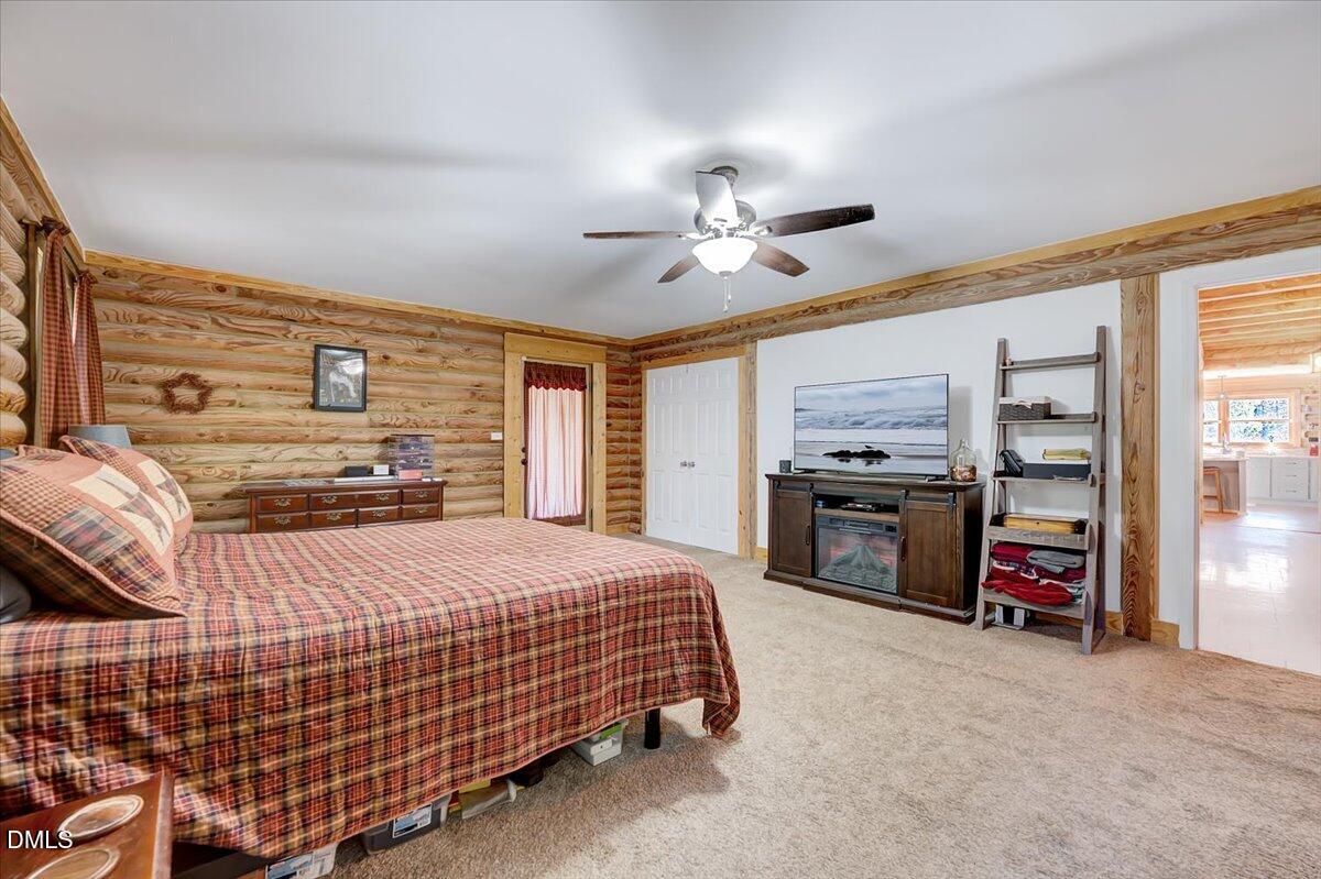 8545 Grassy Creek Road Oxford, NC 27565 - Photo 22 of 39 a bedroom with a bed a dresser and a large window