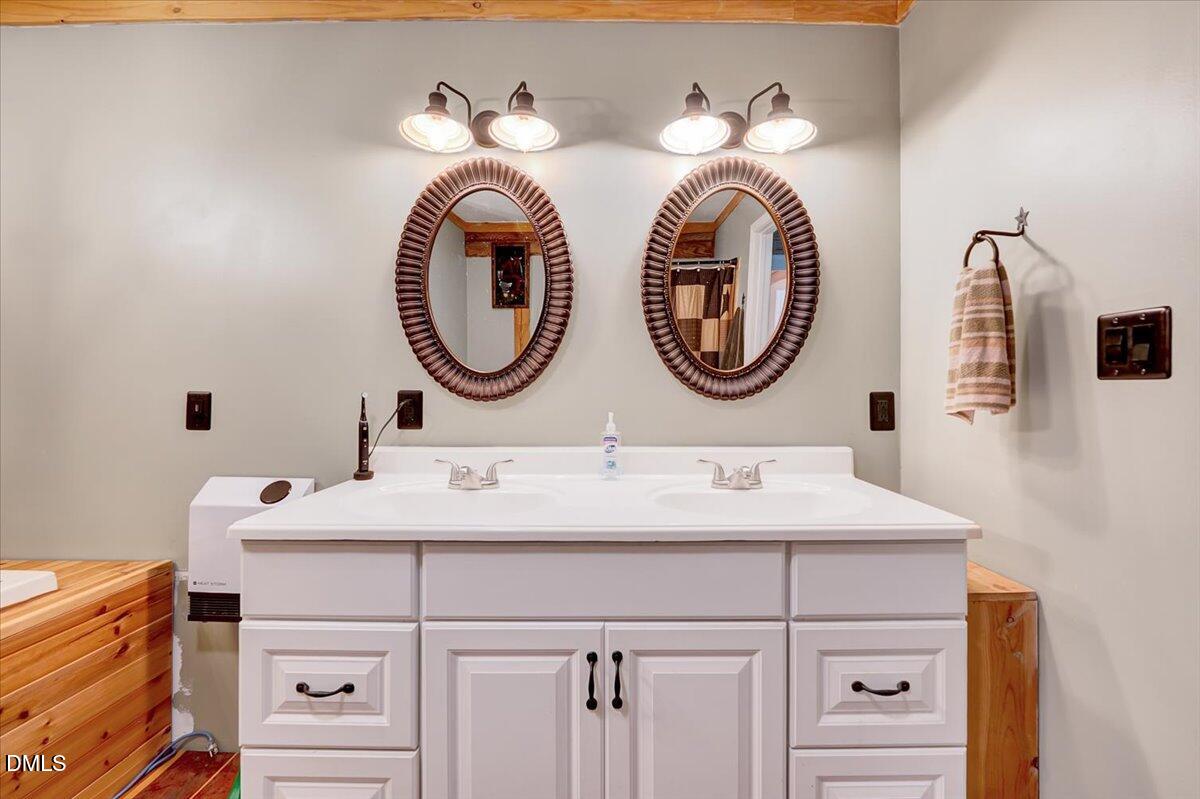 8545 Grassy Creek Road Oxford, NC 27565 - Photo 24 of 39 a bathroom with a sink and a mirror
