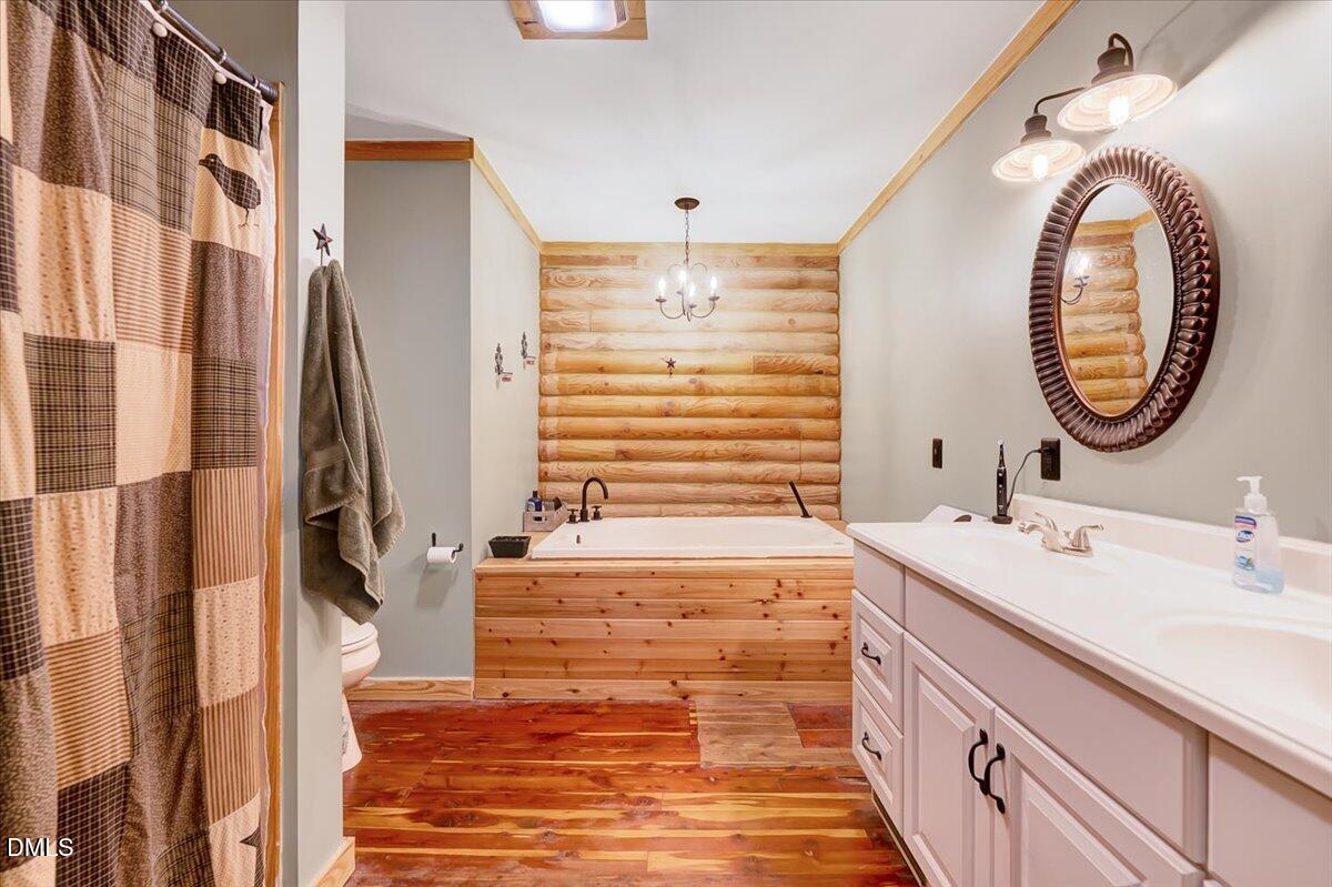 8545 Grassy Creek Road Oxford, NC 27565 - Photo 25 of 39 a bathroom with a sink and a mirror