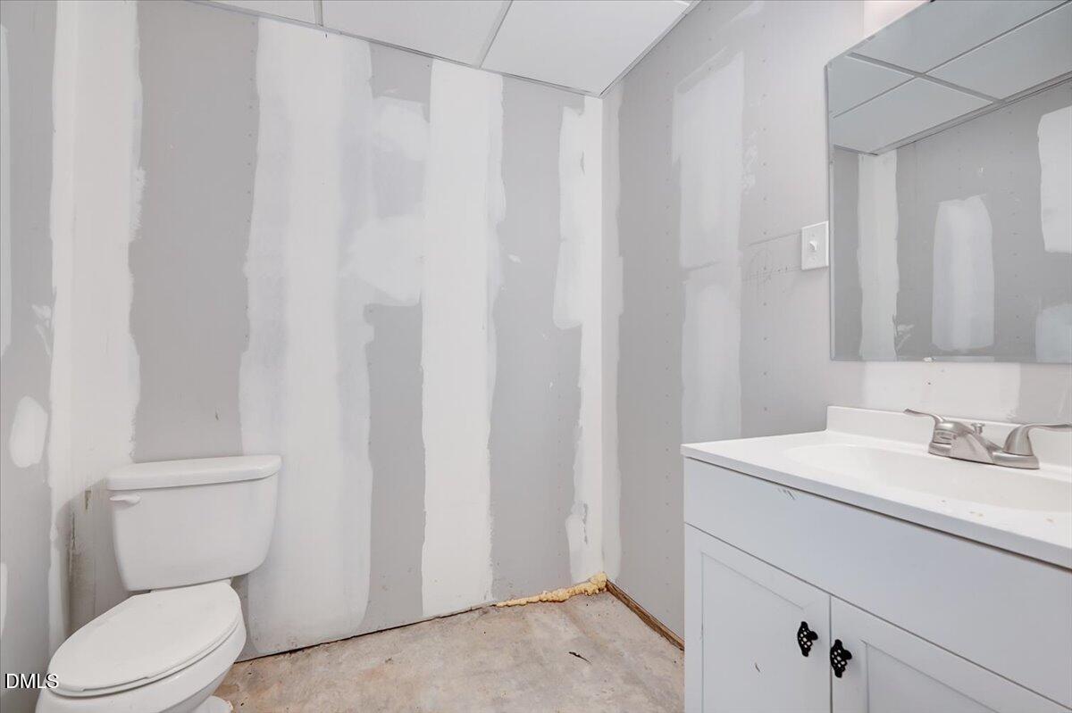 8545 Grassy Creek Road Oxford, NC 27565 - Photo 28 of 39 a bathroom with a sink a toilet and vanity
