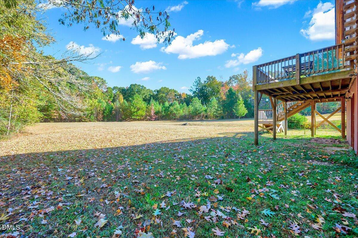 8545 Grassy Creek Road Oxford, NC 27565 - Photo 33 of 39 a backyard of a house with lots of green space and lake view
