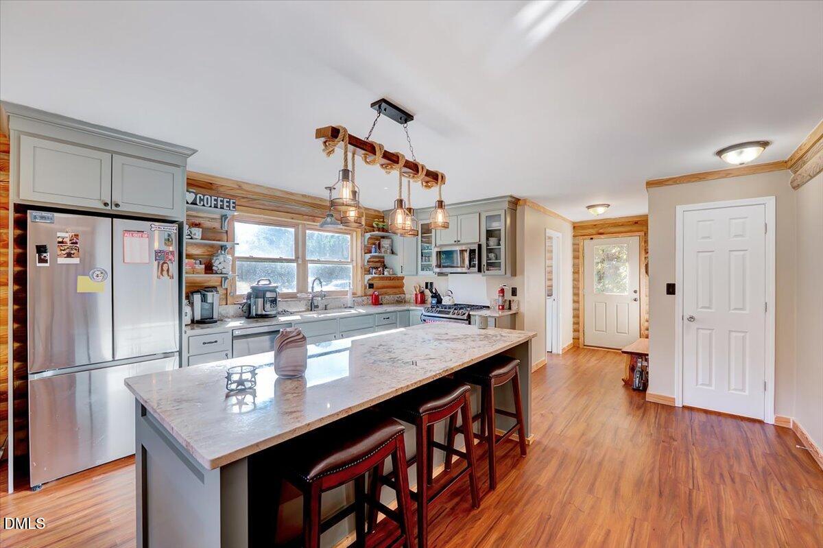 8545 Grassy Creek Road Oxford, NC 27565 - Photo 5 of 39 a kitchen with stainless steel appliances granite countertop a table chairs refrigerator and sink