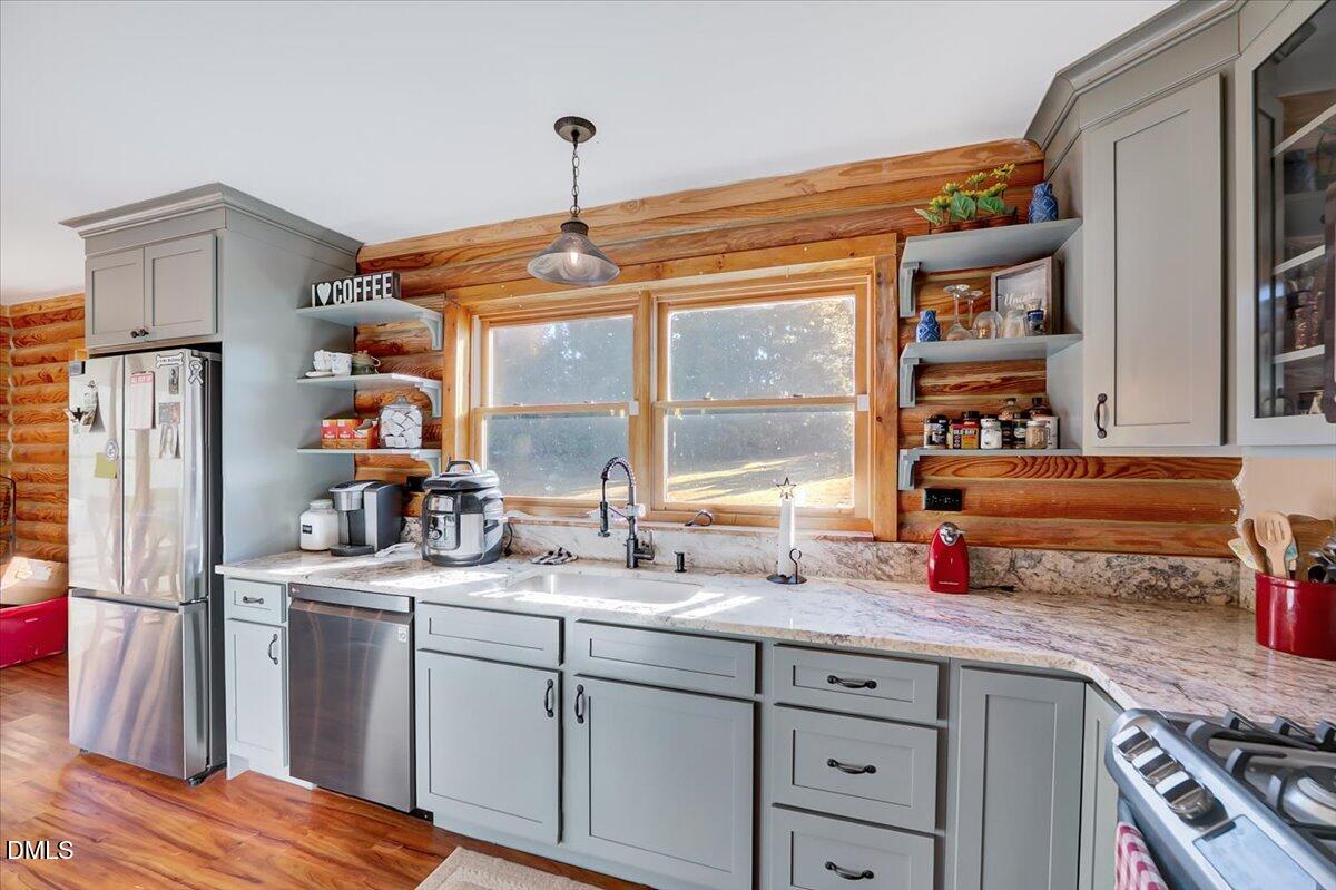 8545 Grassy Creek Road Oxford, NC 27565 - Photo 8 of 39 a kitchen with stainless steel appliances granite countertop a sink stove and refrigerator