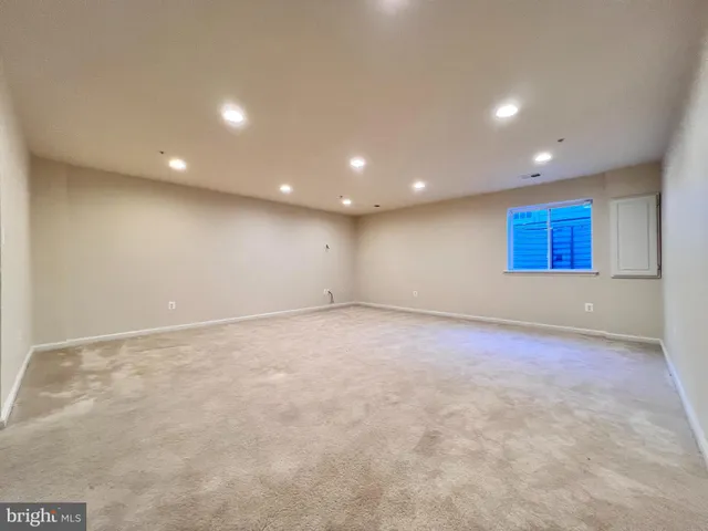 an empty room with a cabinet and mirrors