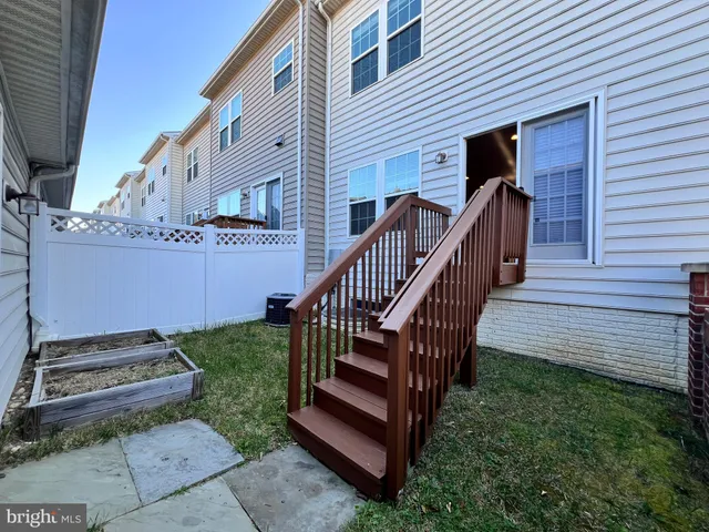 a view of a house with a yard and furniture
