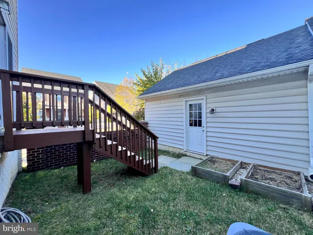 a view of a room with wooden floor and windows