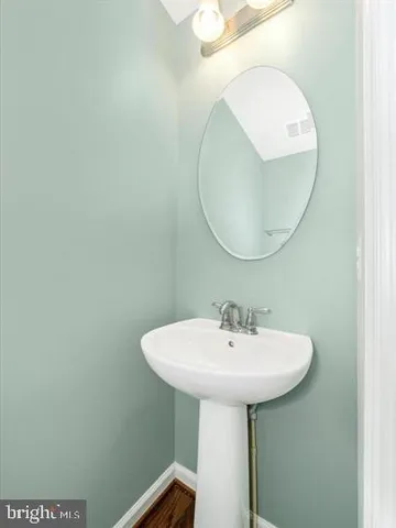 a bathroom with a sink a mirror and a vanity