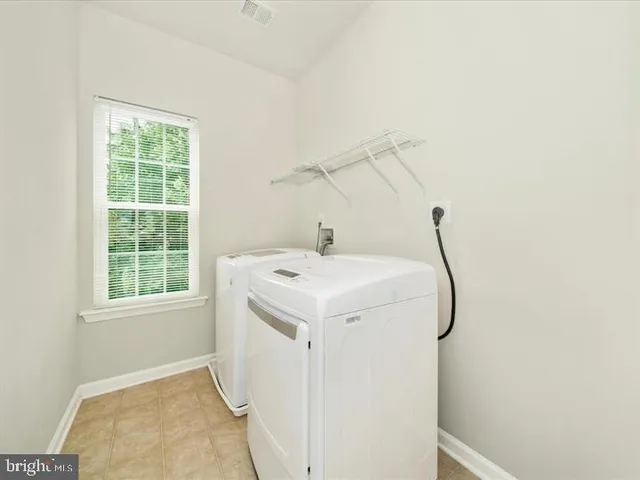 a utility room with a window dryer and washer