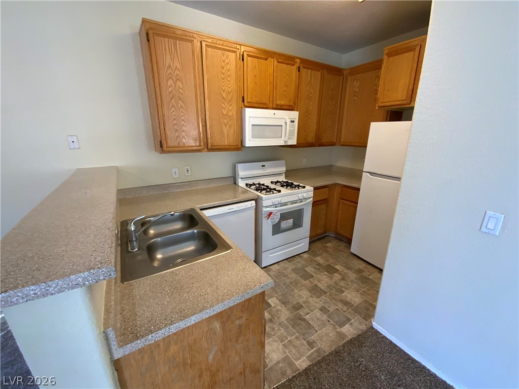 4730 East Craig Road, Unit 1091 Las Vegas, NV 89115 - Photo 6 of 14 Functional kitchen with ample cabinetry and essential appliances for everyday living.