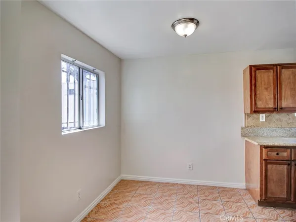 a kitchen with granite countertop a stove and a sink