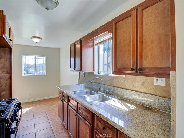 a kitchen with granite countertop a stove and a refrigerator