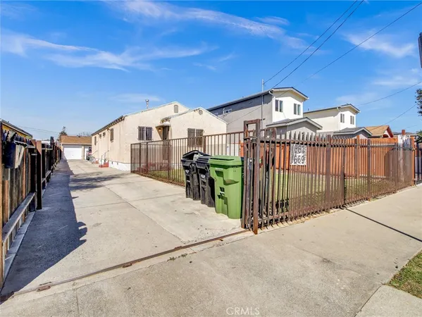 a view of a house with wooden fence