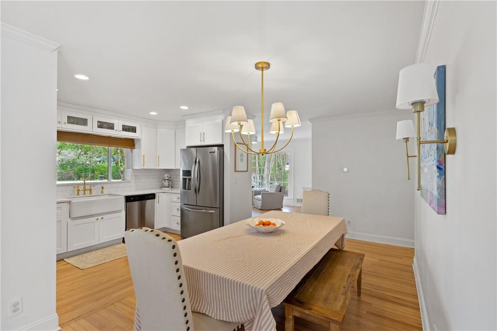3371 King Springs Road Southeast Smyrna, GA 30080 - Photo 11 of 48 a view of a dining room and a kitchen with a table chairs