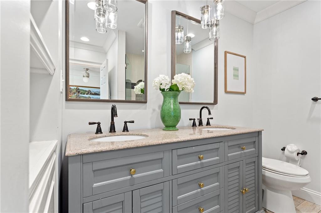 3371 King Springs Road Southeast Smyrna, GA 30080 - Photo 25 of 48 a bathroom with a granite countertop sink vanity mirror and toilet